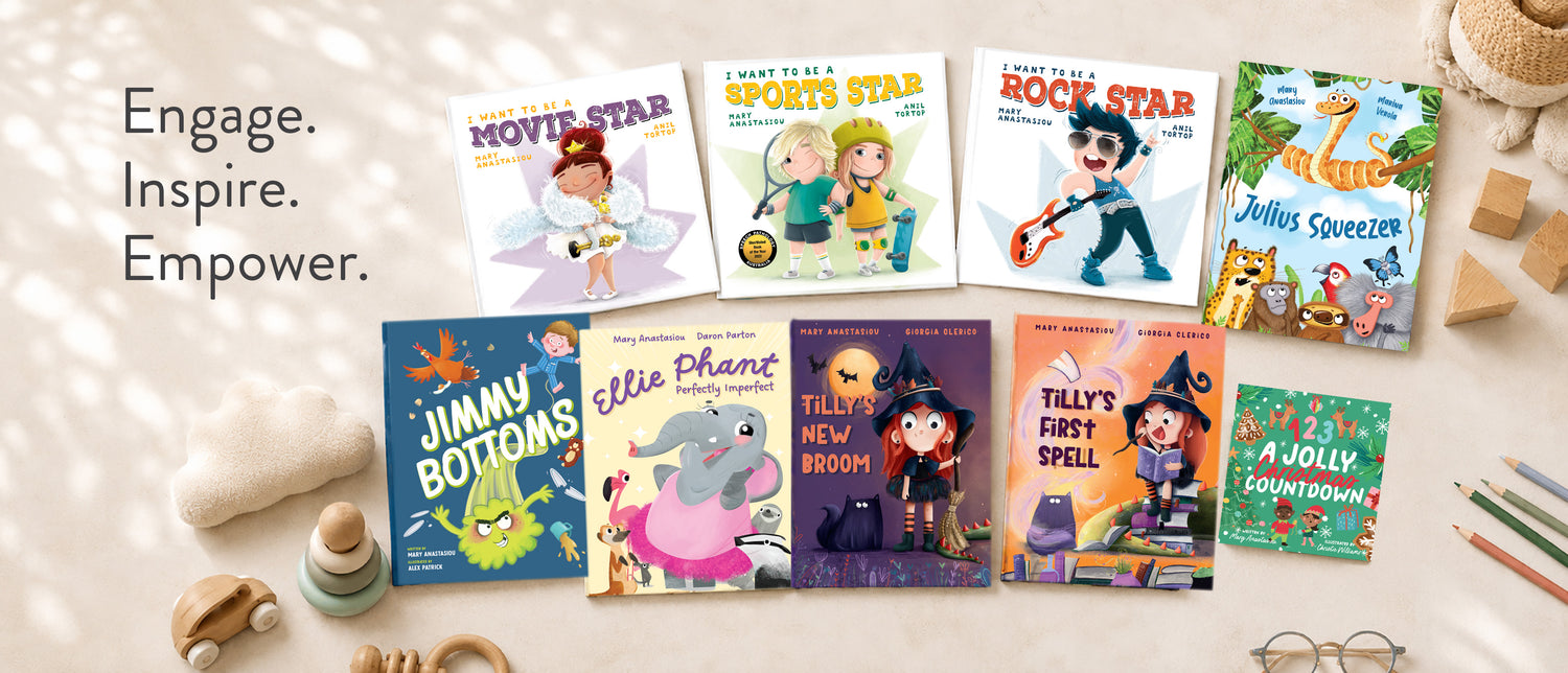 Collection of children's books written by Mary Anastasiou on a soft surface with toys and stationery items.