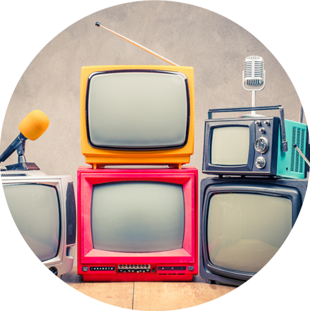 stack of vintage television sets and microphones