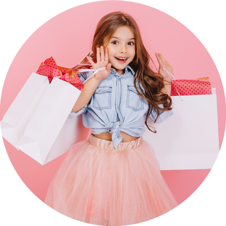 Young girl with shopping bags on oink background